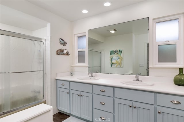 bathroom featuring walk in shower, vanity, toilet, and wood-type flooring