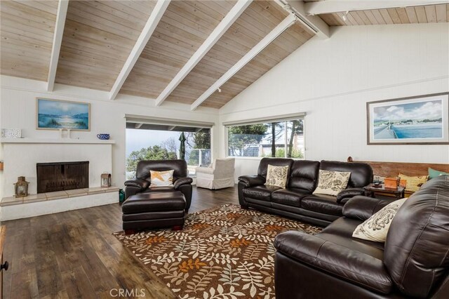 living room with wood walls, beamed ceiling, and dark hardwood / wood-style floors