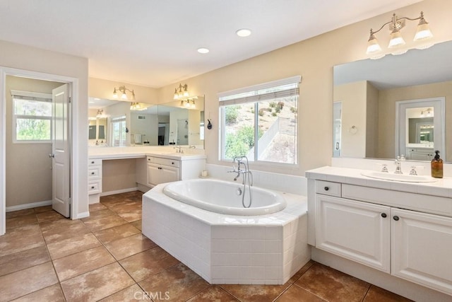 bathroom with vanity, tile patterned floors, and tiled bath