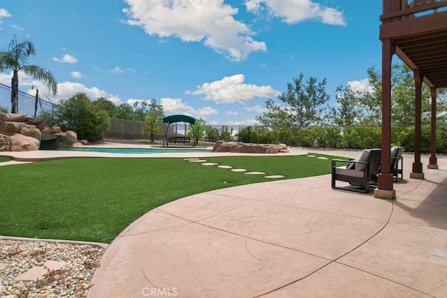 view of community with a pool, a patio, and a lawn