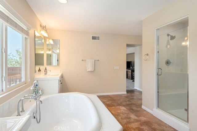 bathroom with shower with separate bathtub, vanity, and tile patterned flooring