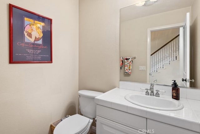 bathroom featuring toilet and vanity