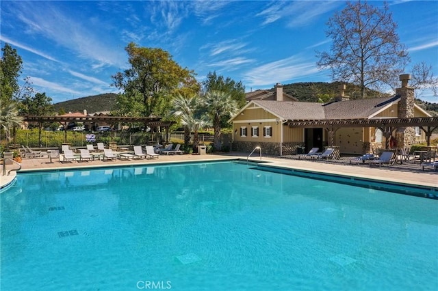 view of swimming pool with a patio area and a pergola