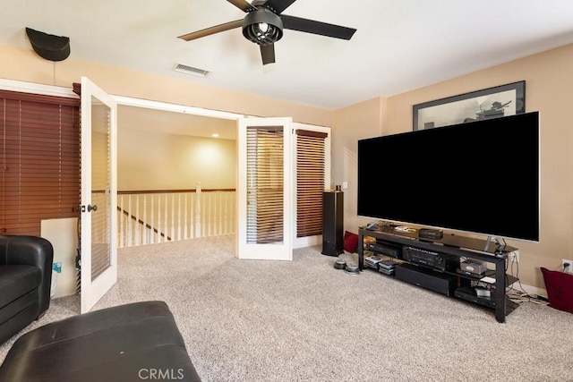 living room with ceiling fan and carpet floors