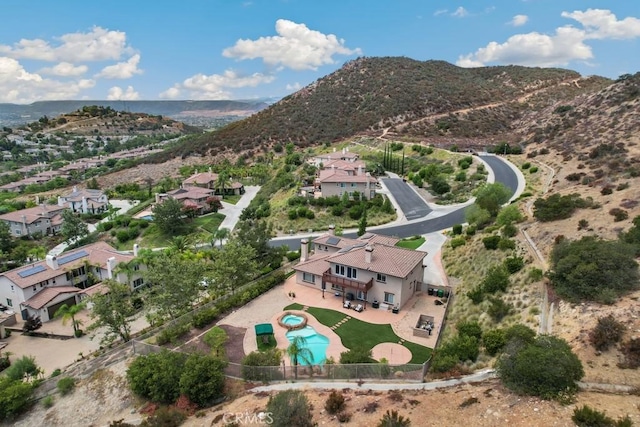 birds eye view of property with a mountain view