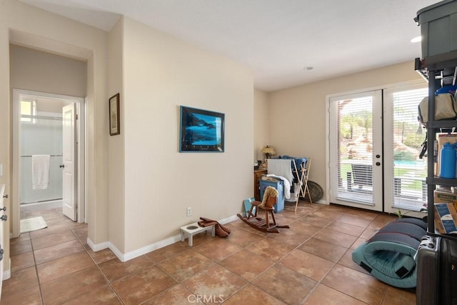 exercise room featuring light tile patterned floors