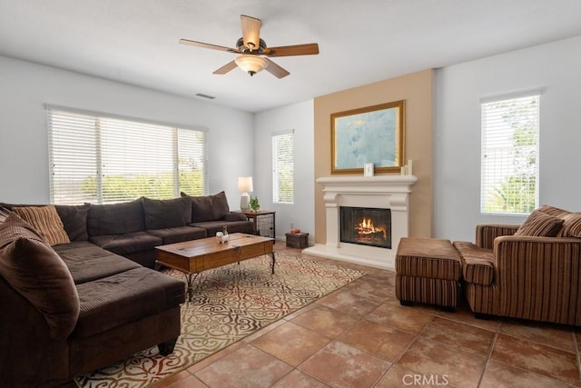 tiled living room with ceiling fan