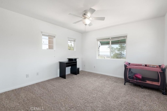 bedroom with ceiling fan, carpet flooring, and multiple windows