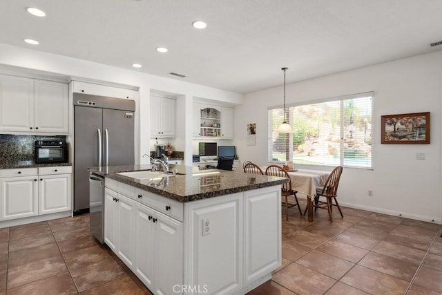 kitchen featuring white cabinets, a center island with sink, dishwasher, and sink