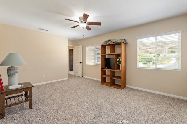 carpeted living room featuring ceiling fan