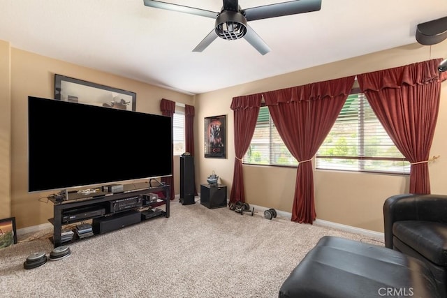 carpeted living room with ceiling fan and a wealth of natural light