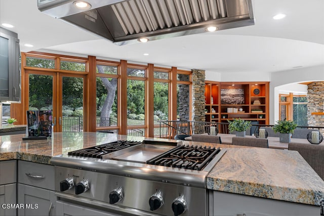 kitchen featuring gray cabinetry, stone countertops, and ventilation hood