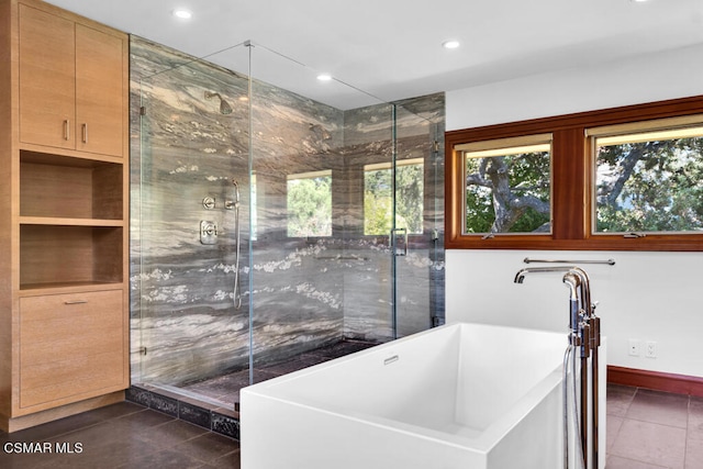 bathroom with independent shower and bath and tile patterned flooring