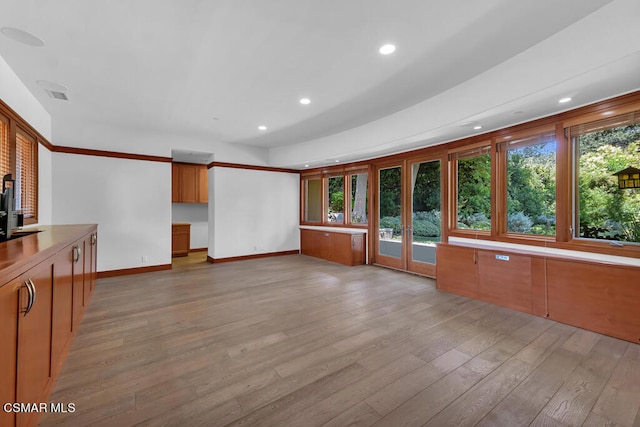 unfurnished living room featuring french doors and light wood-type flooring