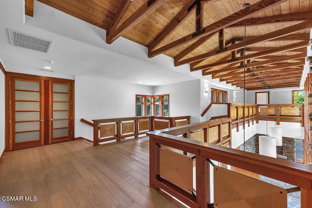 corridor with hardwood / wood-style flooring, wooden ceiling, and vaulted ceiling with beams