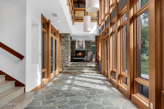 corridor featuring a high ceiling and plenty of natural light