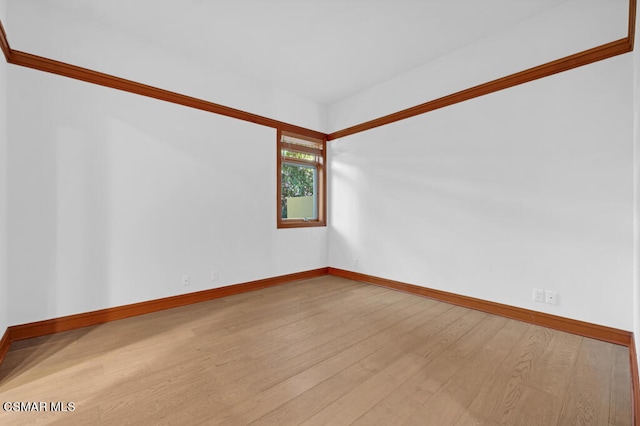 spare room with light wood-type flooring