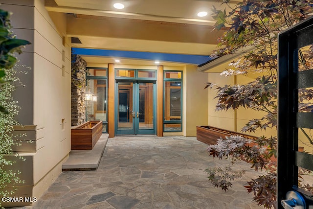 entrance to property with a patio area and french doors