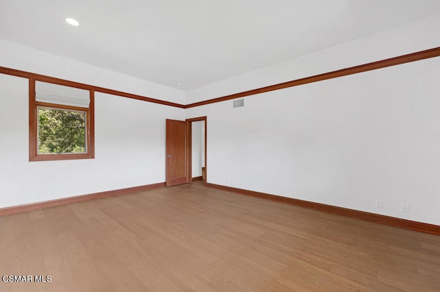 unfurnished room with light hardwood / wood-style floors