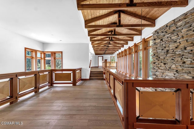 corridor featuring vaulted ceiling with beams, wood ceiling, and wood-type flooring