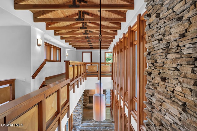 hallway featuring wood ceiling, beam ceiling, and high vaulted ceiling