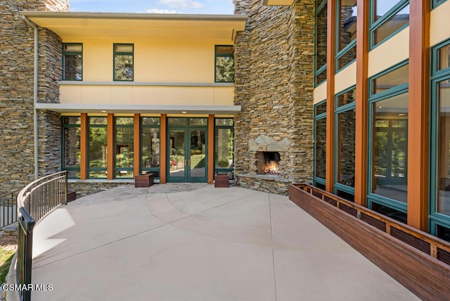 view of patio with an outdoor stone fireplace