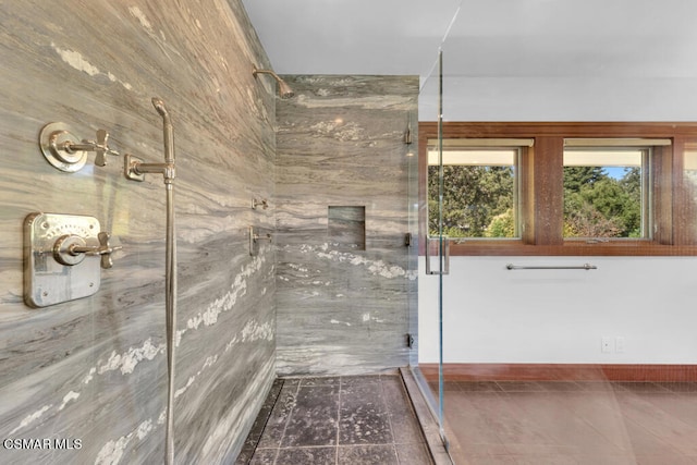 bathroom featuring a shower with shower door