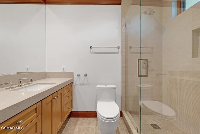 bathroom featuring toilet, a shower with shower door, and vanity