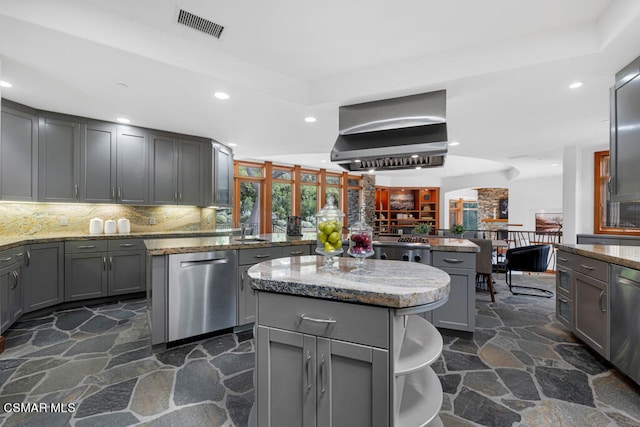 kitchen featuring gray cabinets, dishwasher, a center island, and ventilation hood