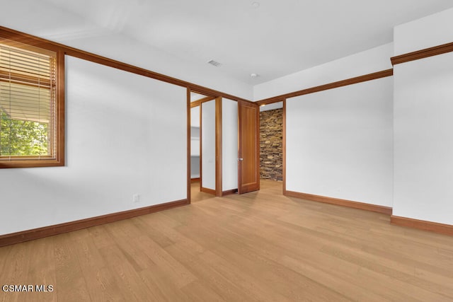 spare room featuring light wood-type flooring