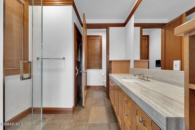 bathroom with vanity, toilet, and a shower with shower door