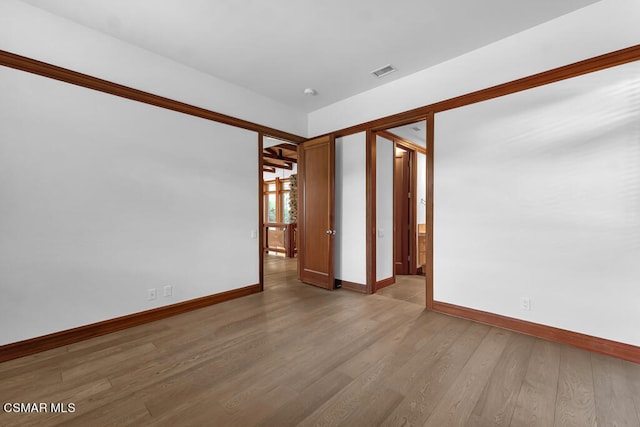 unfurnished room with hardwood / wood-style flooring