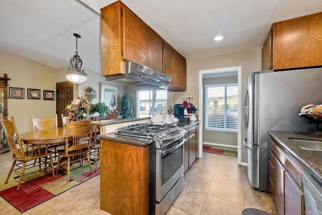 kitchen featuring appliances with stainless steel finishes, plenty of natural light, pendant lighting, and light tile patterned floors