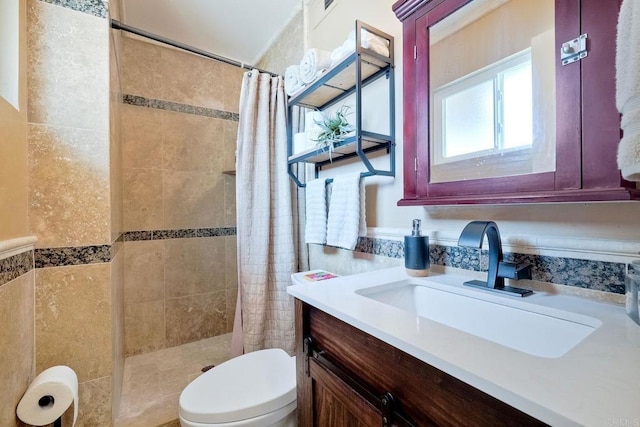 bathroom featuring toilet, vanity, and a shower with shower curtain