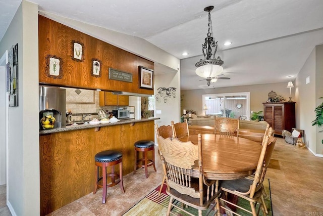 dining space featuring lofted ceiling and ceiling fan