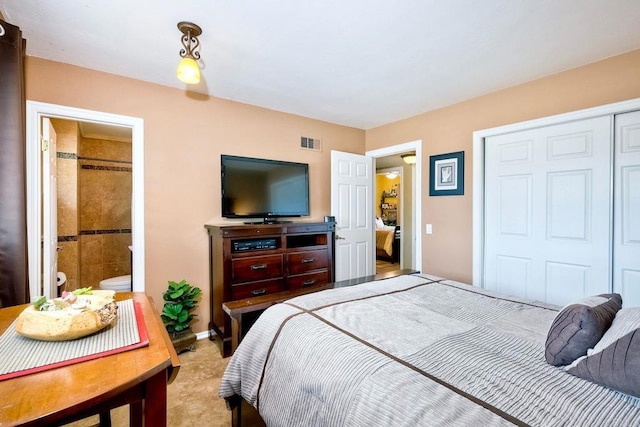 bedroom featuring ensuite bath and a closet