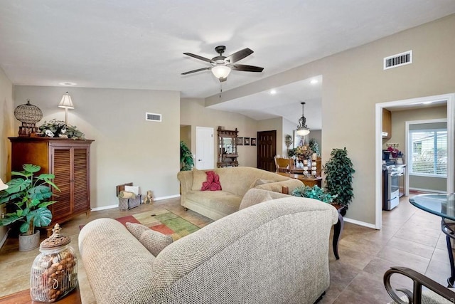 living room with ceiling fan, lofted ceiling, and tile patterned floors