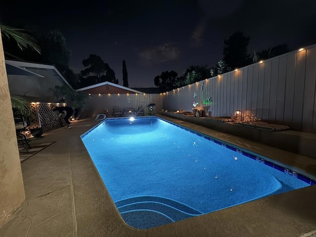 pool at night with a patio