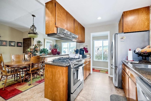 kitchen with pendant lighting, light tile patterned floors, and appliances with stainless steel finishes