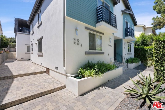 view of property exterior with a patio