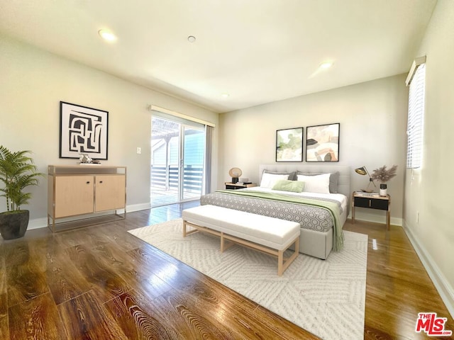 bedroom featuring dark wood-type flooring and access to exterior