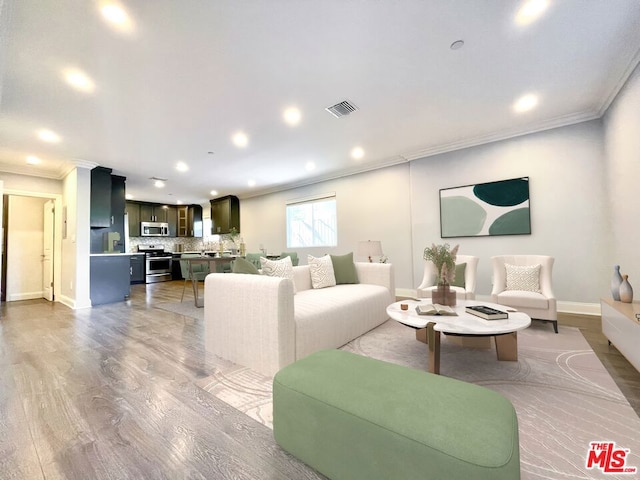 living room featuring crown molding and light hardwood / wood-style floors