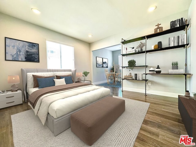 bedroom with dark hardwood / wood-style floors