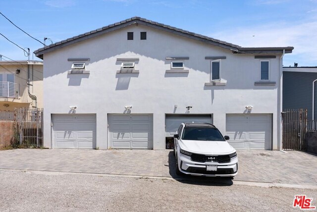 rear view of property featuring a garage