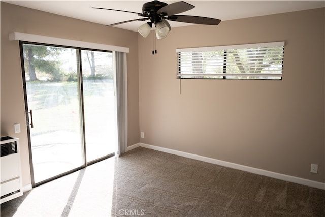 spare room featuring ceiling fan, radiator, and carpet floors