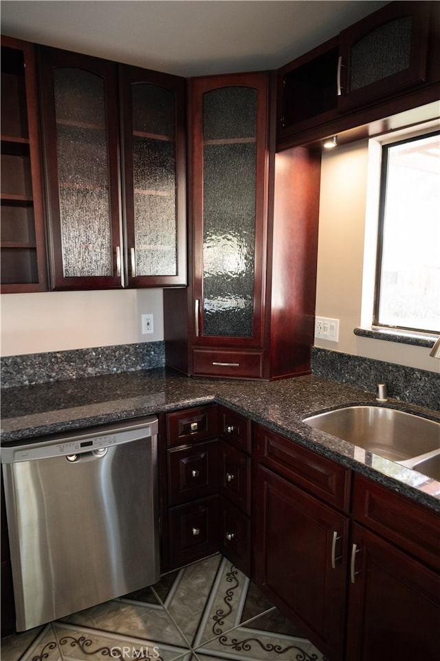 kitchen with dishwasher, sink, and light tile patterned flooring