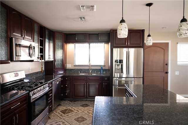 kitchen featuring dark brown cabinets, stainless steel appliances, plenty of natural light, and sink