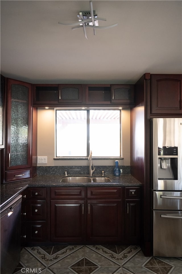 kitchen featuring stainless steel fridge, dishwasher, dark brown cabinets, sink, and tile patterned floors