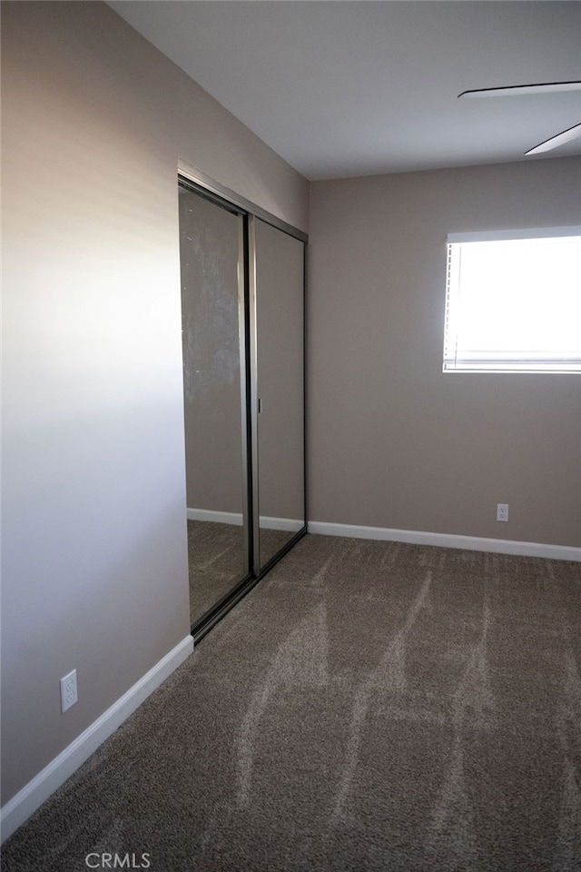 unfurnished bedroom with a closet and carpet