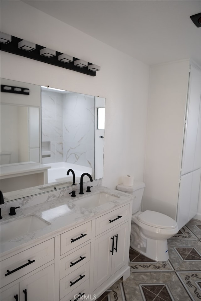 bathroom featuring tile patterned floors, vanity, and toilet